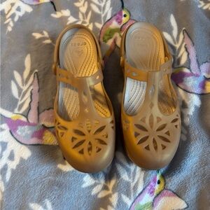 Crocs Gold Slip Ons with unique flower pattern design